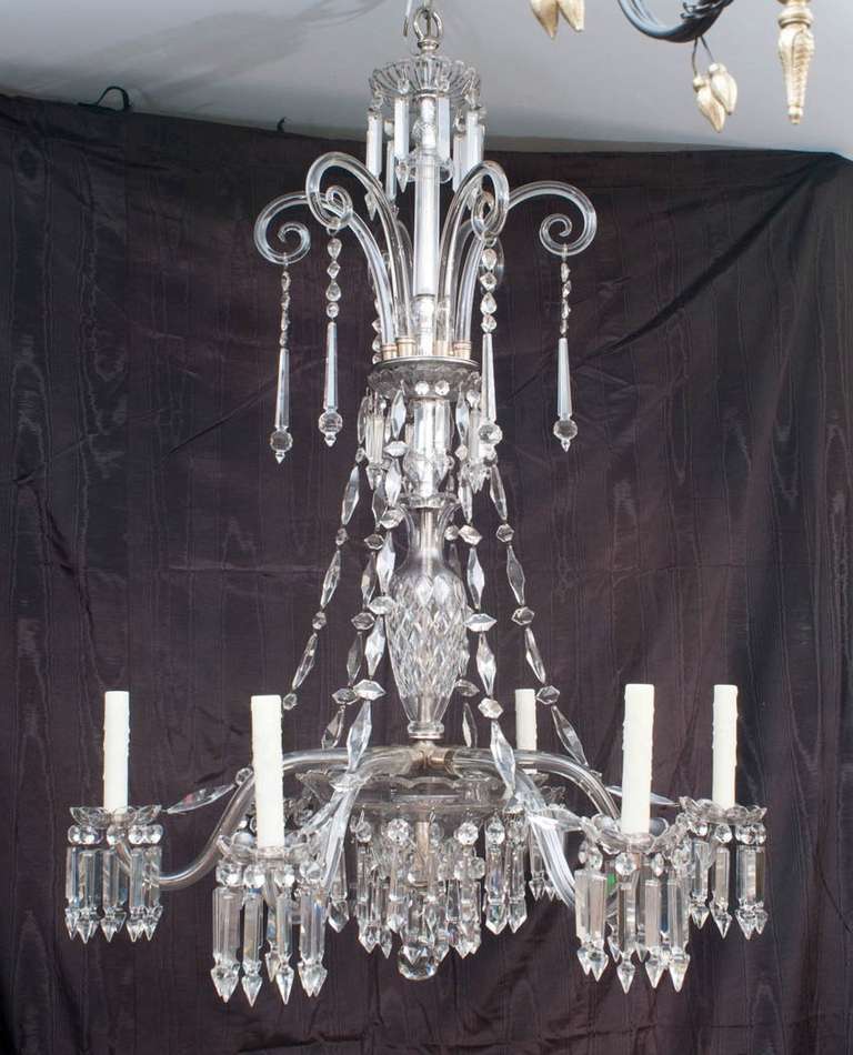 This hand-cut and hand-blown lead crystal chandelier was originally designed for either gas or candle but later electrified - unusual arm configuration - the cut crystal vase in the center of the stem is an Osler signature design element, as is the