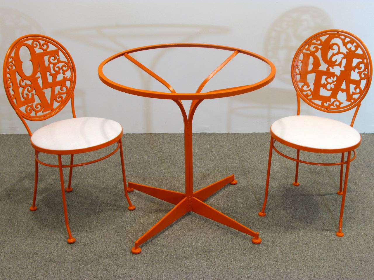 Enameled orange Cafe set includes two chairs and table one chair back spells LOVE and one PEACE