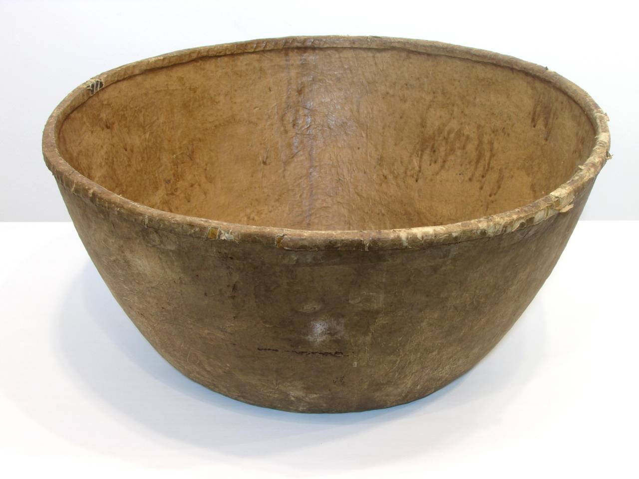Vintage very large fiber bowl covered in brown paper with covered split bamboo rim