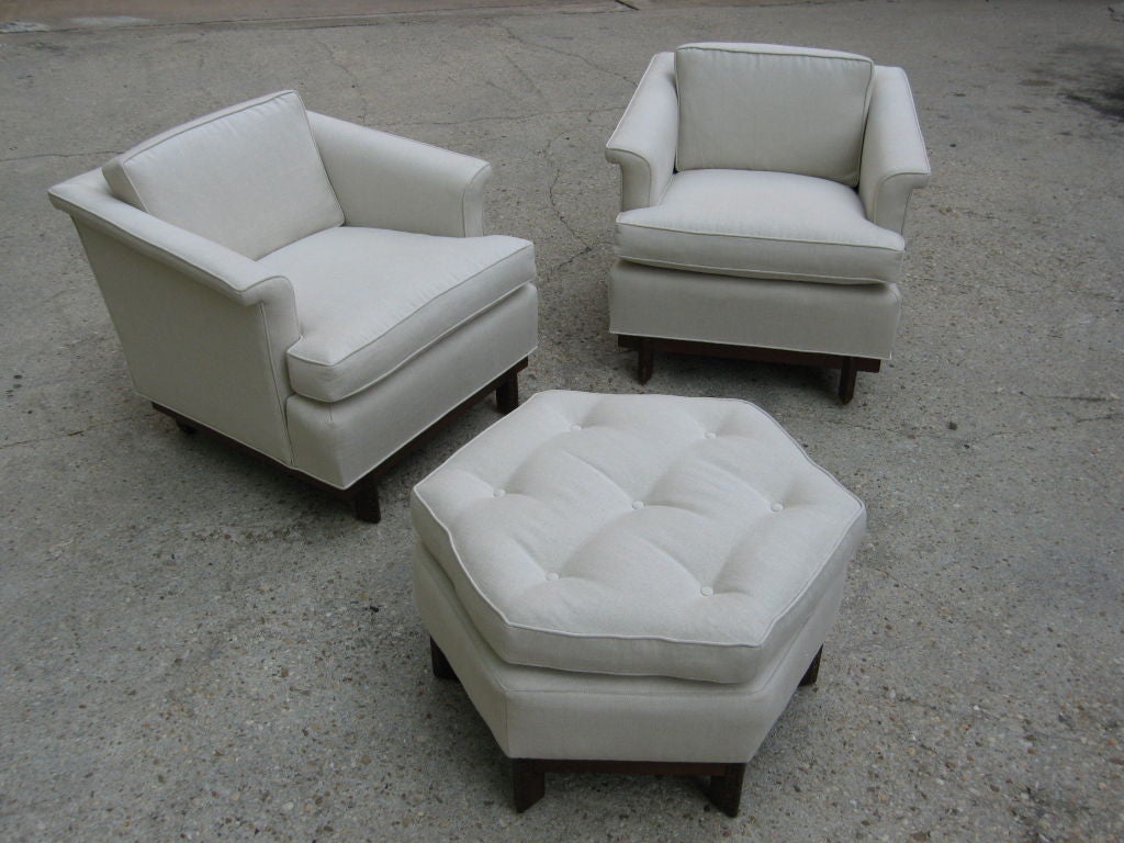 Pair of arm chairs and a hexagon ottoman all with Tailsman design frame by Frank Lloyd Wright for Heritage Henredon
