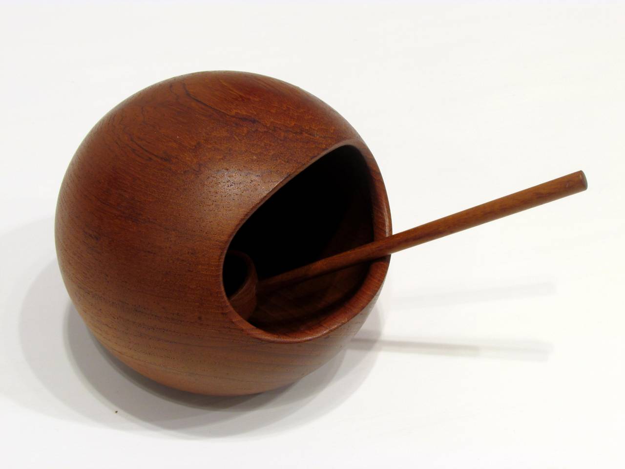 Orb shaped teak bowl with long handled spoon designed by Sigvard Nilsson  for use as a nut bowl both spoon and bowl are marked Sowe Konst