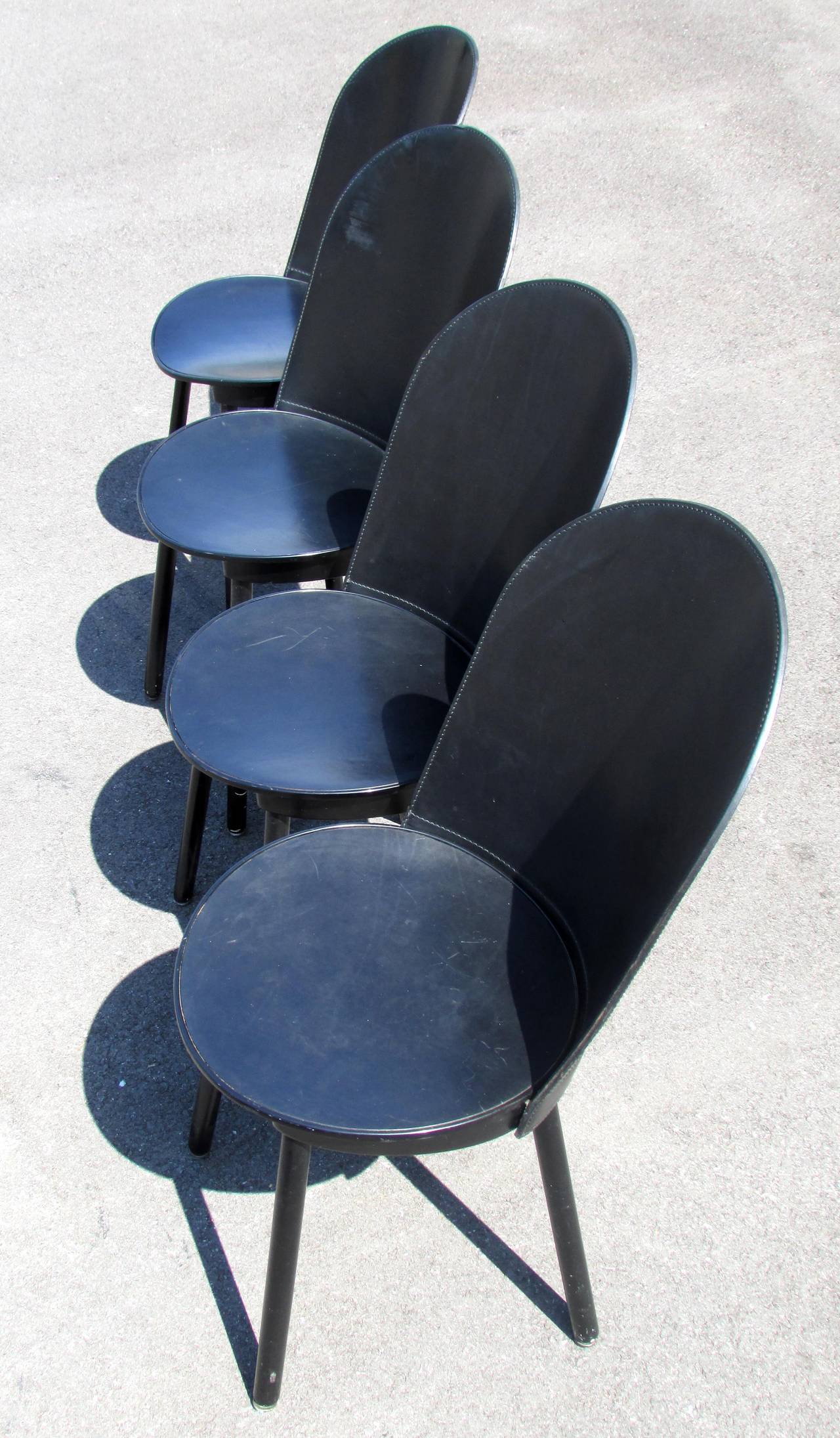Set of four black leather curved back chairs with screw in wooden dowel legs these 