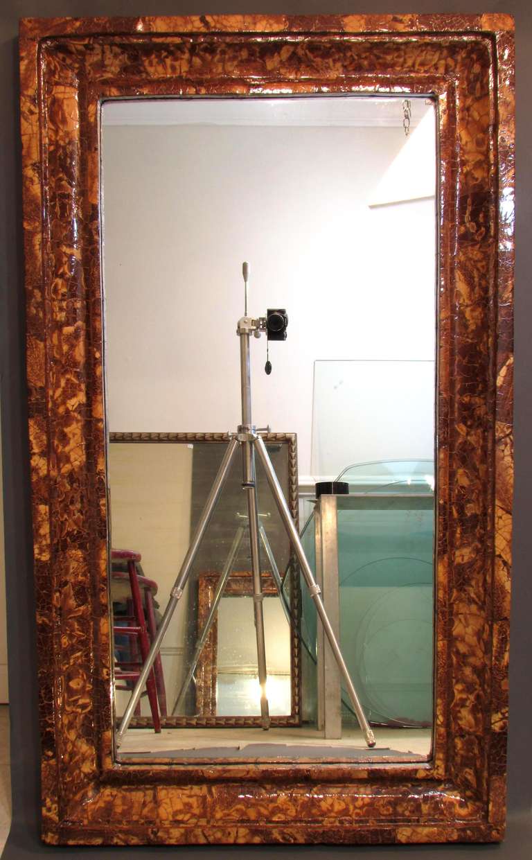 Large mirror with crushed coconut shell covered frame.