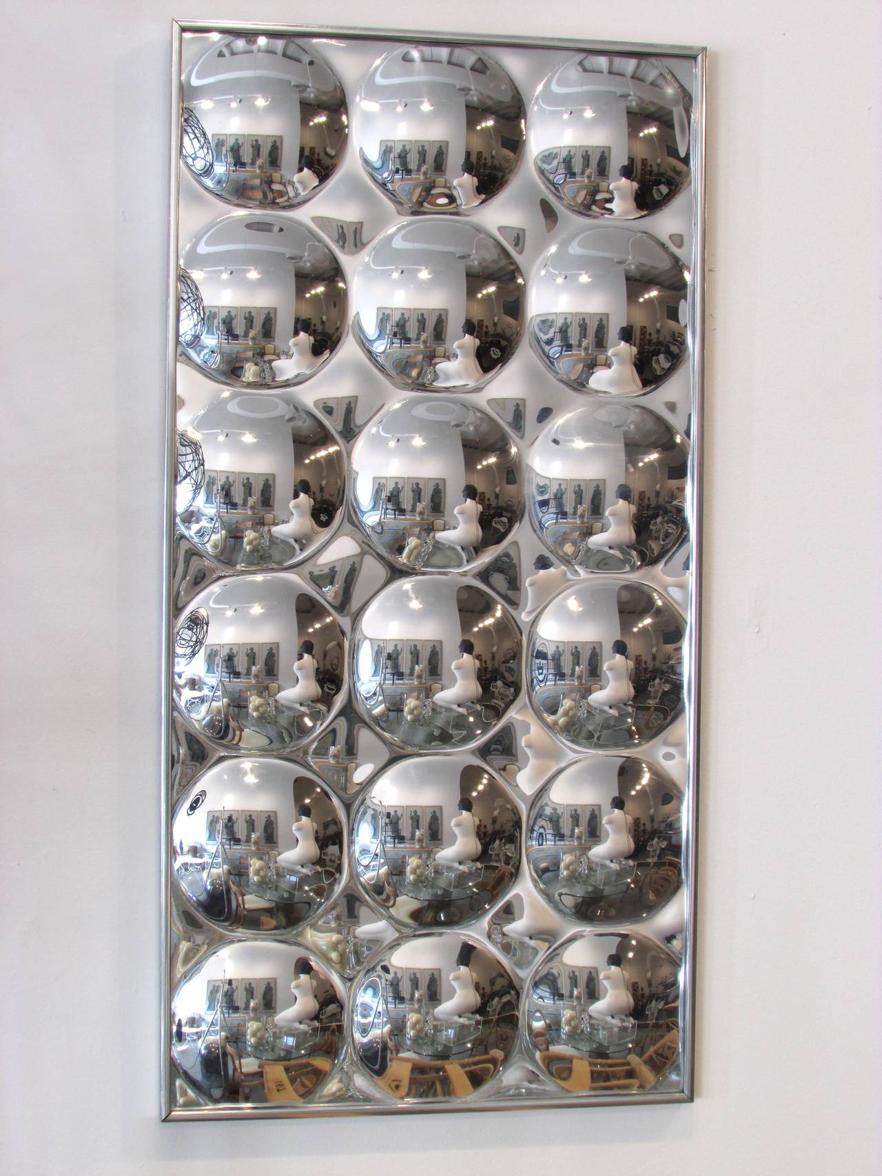 Silvered plastic dimpled mirror framed in silver frame