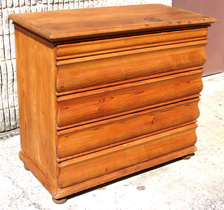 Sculptural hard pine chest of four drawers from French Alps includes key for side locking mechanism on bun feet.