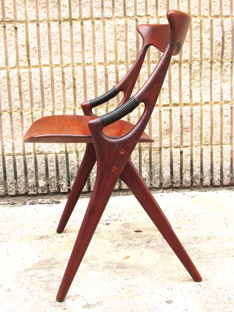 Sculptural chair with scissor legs and handles for arm rest by Arne Hovmand-Olsen