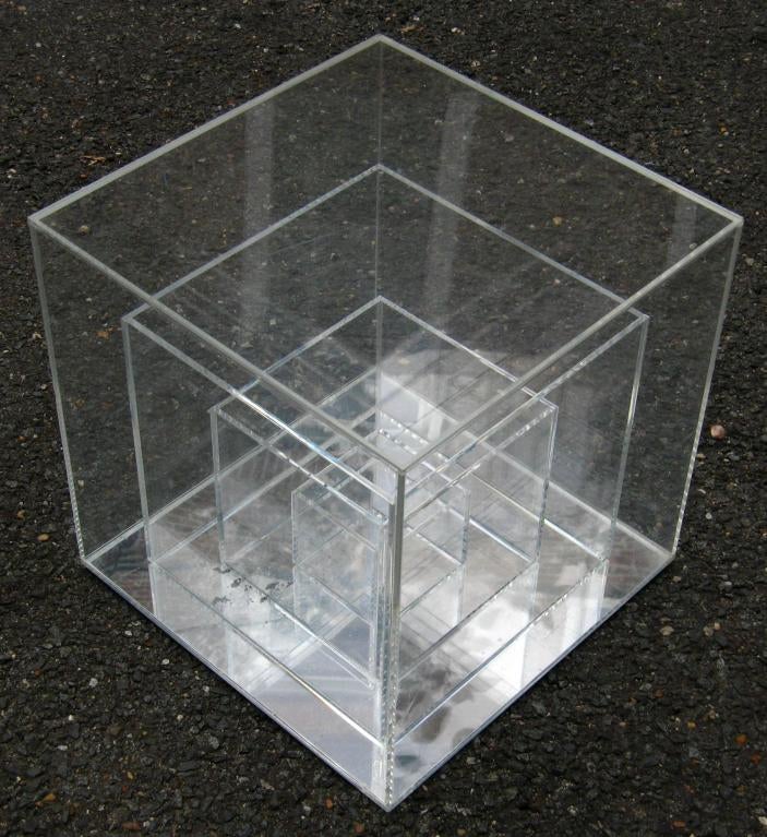 Small square sculptural lucite side table consisting of four squares of descending size with mirrored bottom
