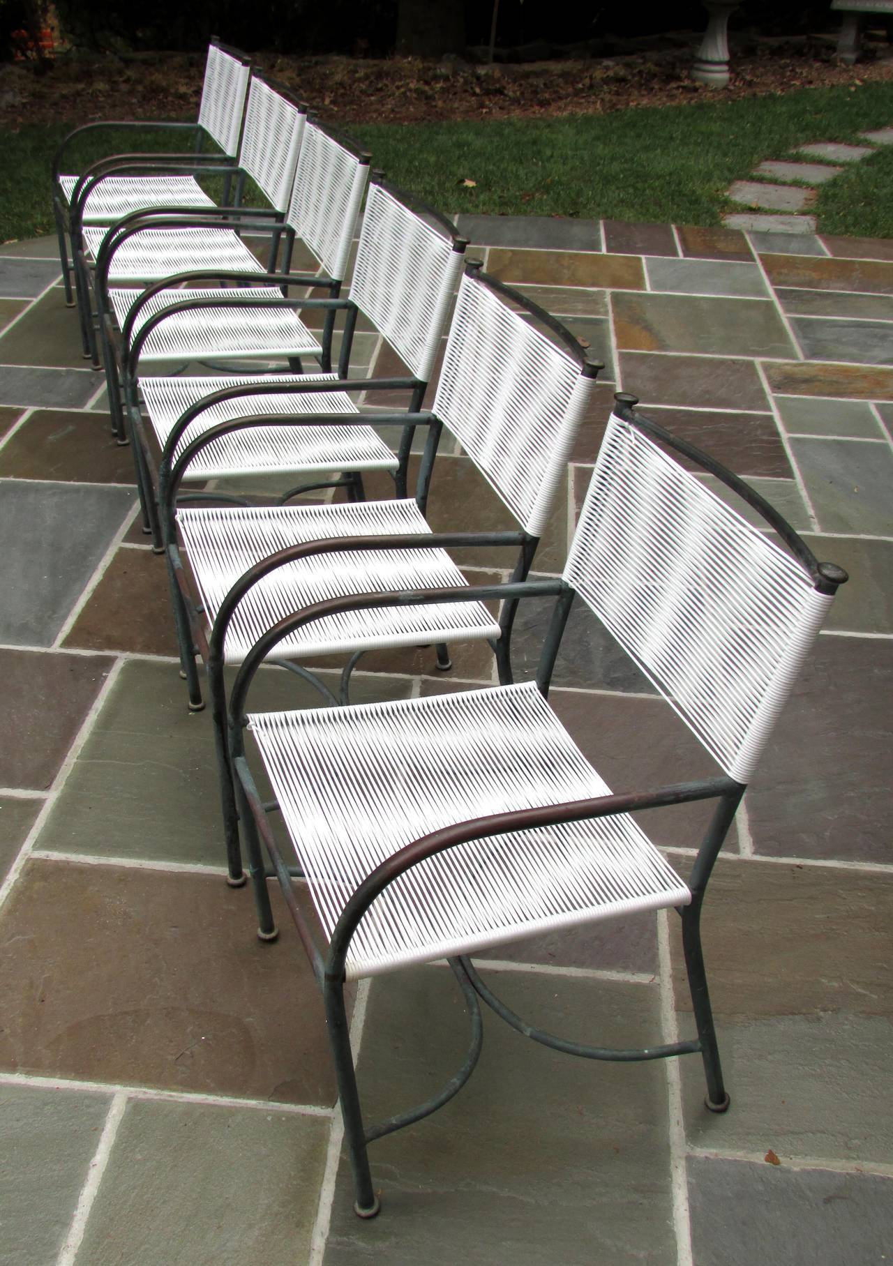 Beautiful set of six bronze tubing chairs with old patina and new parachute cording seats and backs.