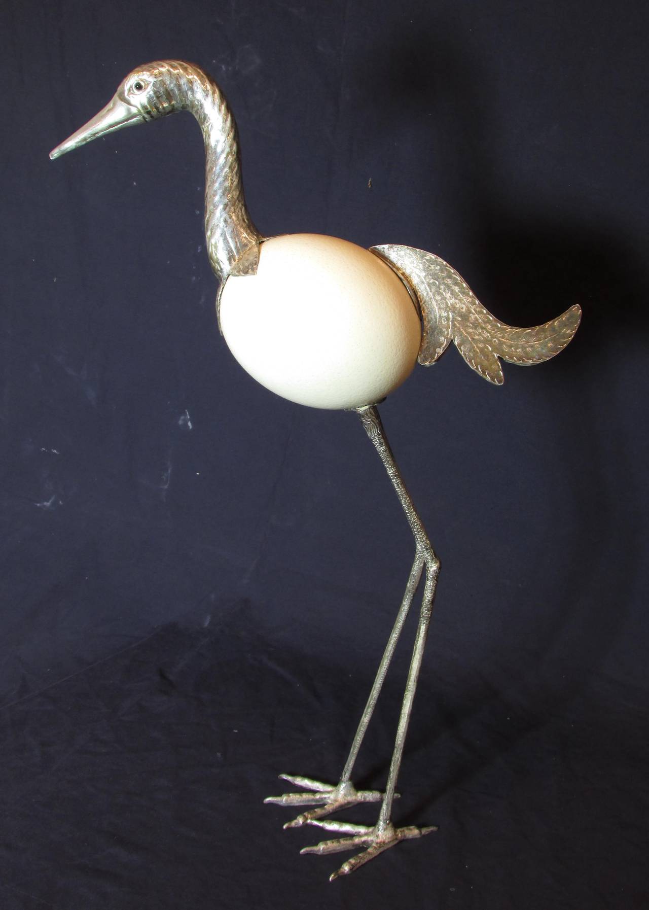 Tall crane bird sculpture made with body of ostrich egg and feet, tail and head is silver plated brass with glass eyes, unsigned in the style of Anthony Redmile & Binazzi Foresto