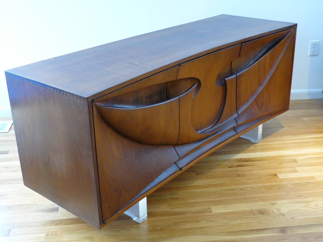 An early Michael Coffey piece, included with a signed letter from Coffey to the original owners, dated 1972.

Solid walnut, dramatic, deeply carved sculptural front and hand-cut dovetail joinery on the top and bottom of both sides. Three solid