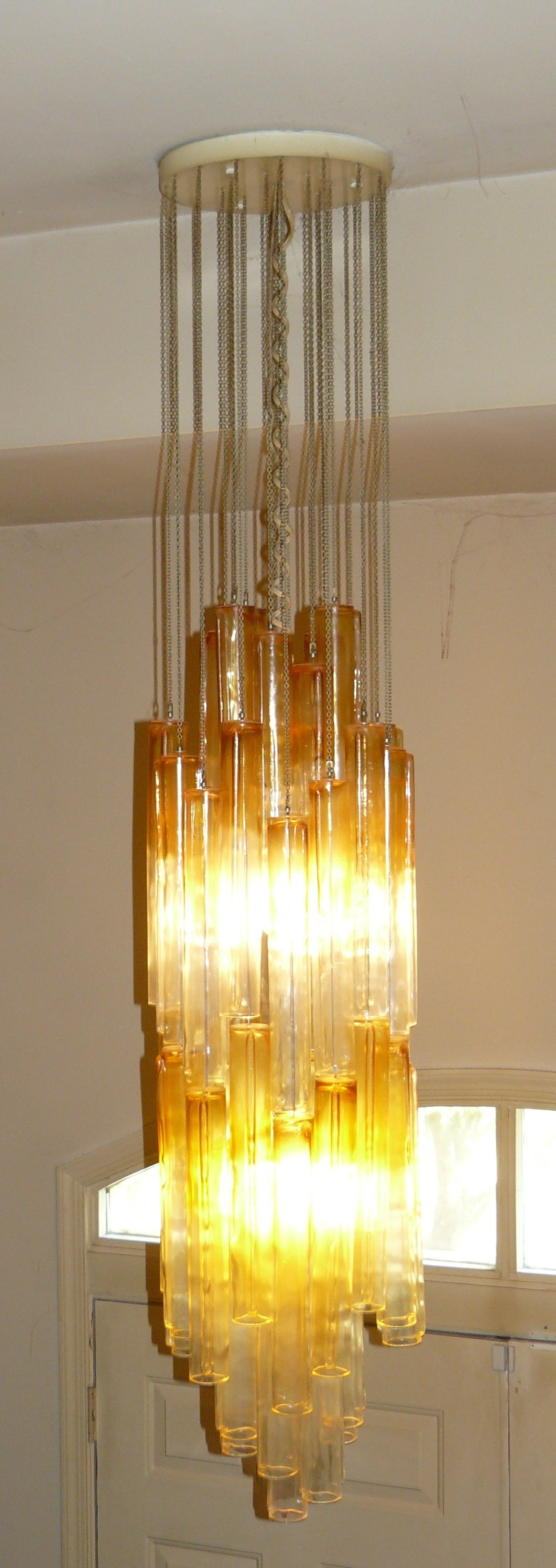 1970s amber and clear glass Mazzega Murano chandelier. Comprised of 49 Murano glass tubes (each 14.5