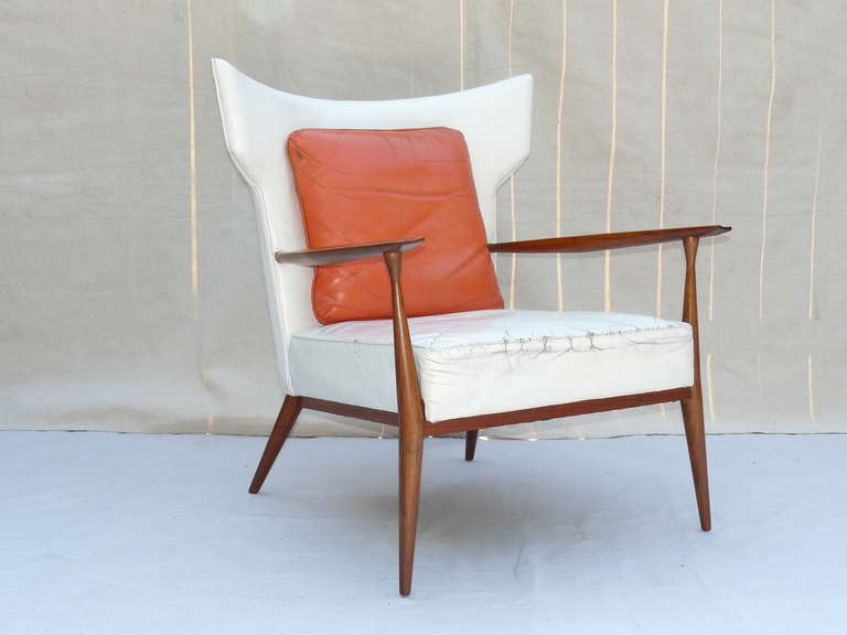 RARE Leather Paul McCobb Directional Wing Chair model # 1329. Arguably McCobb's most important lounge seating design. Upholstered in original white leather with original orange leather back cushion. A museum quality example.