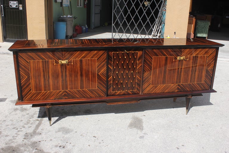 From our latest container, a long French Art Deco exotic Macassar ebony buffet or credenza. Center drop down bar area. Spacious interior finished in lemonwood. Beautiful inlay.