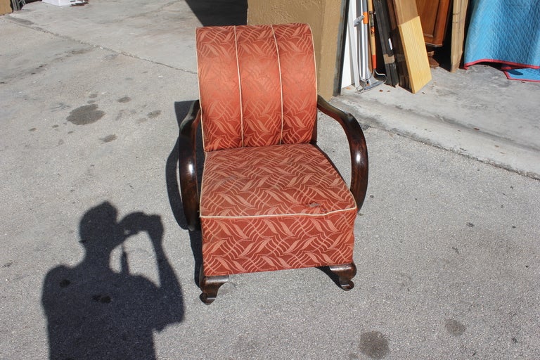Pair of French Art Deco curved arm solid walnut club chairs.