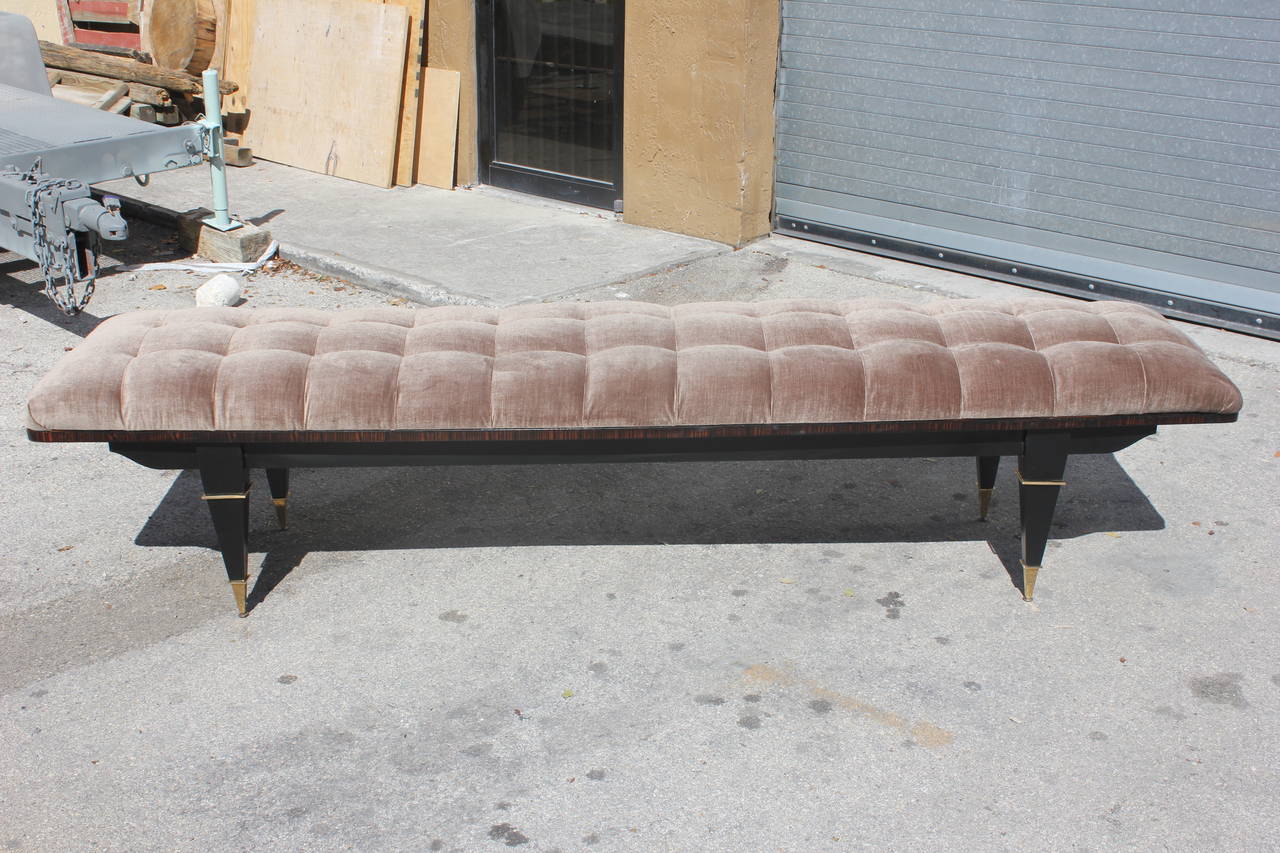 A French Art Deco black lacquered/Macassar ebony upholstered sitting bench, circa 1940s. Brass capped legs. From a French hotel. Would be great in a bedroom.