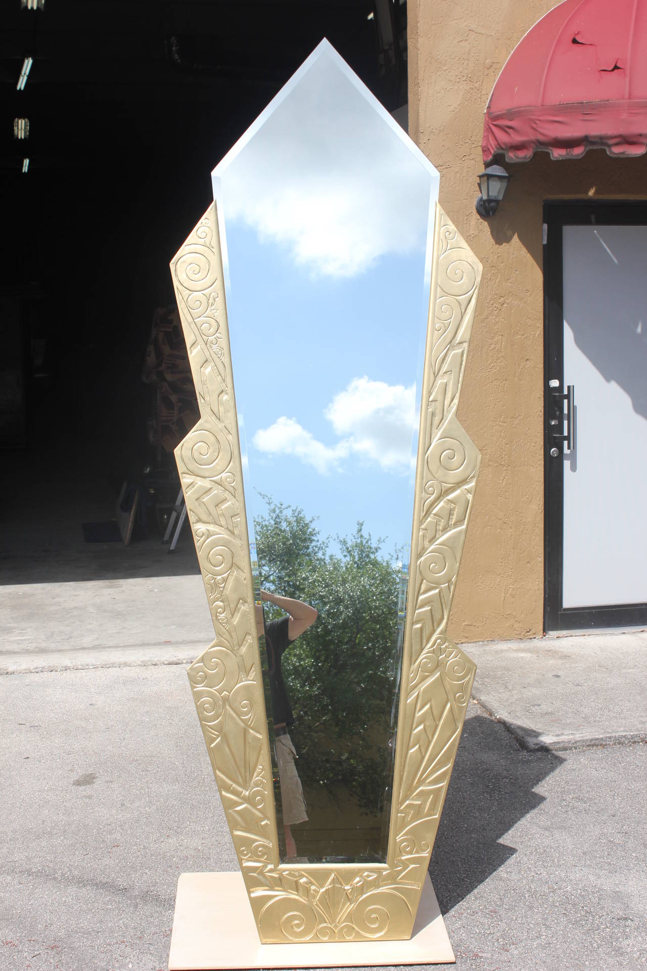 A monumental French Art Deco gilt plaster over wood mirror, measuring 94