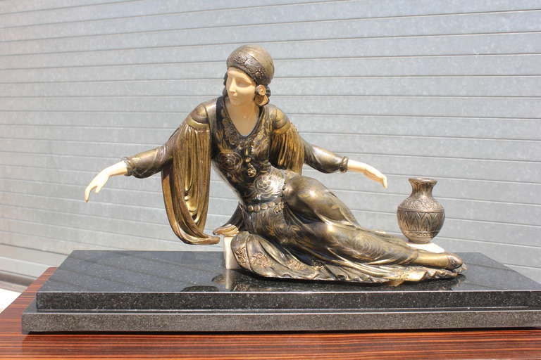 A French Art Deco Patinated Metal Sculpture Of a Deco Lady on Marble Base.