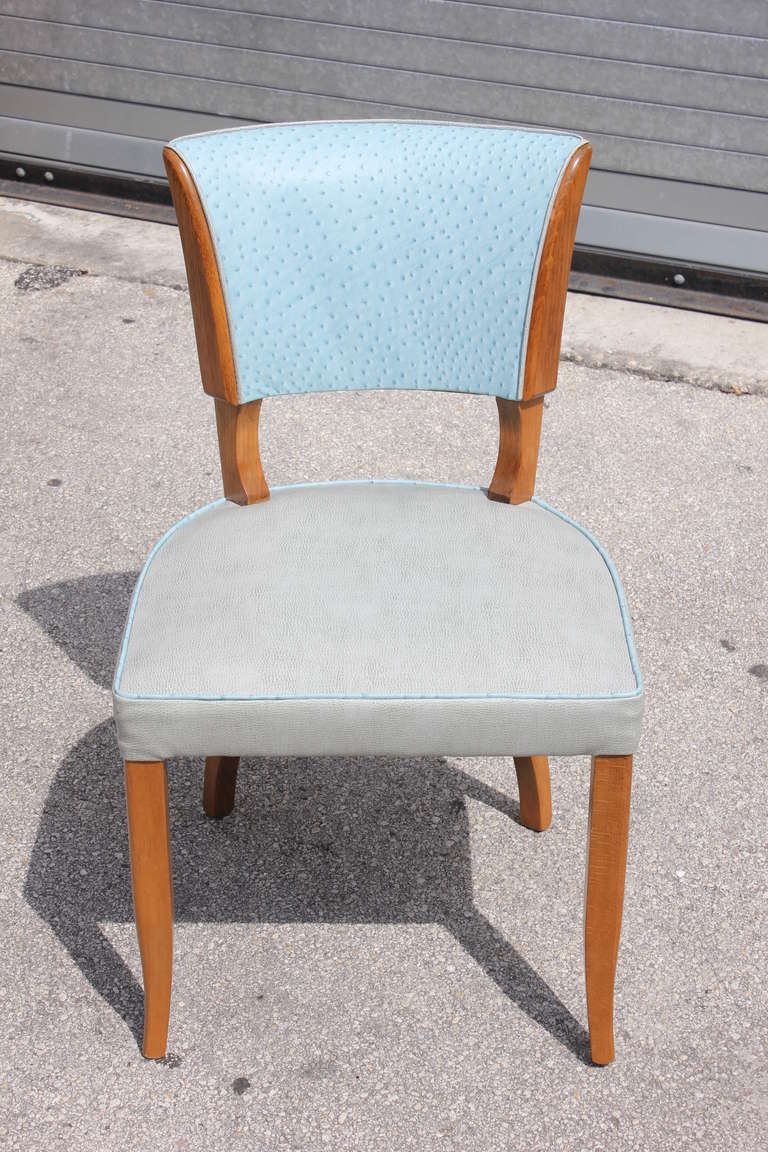 A fantastics set of 5 French Art Deco solid walnut dining chairs, newly refinished and reupholstered in a two-toned leather composition. Upper back upholstered in a baby blue ostrich embossed leather and the seat and rear portion of back upholstered