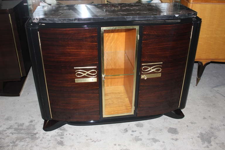 A Beautiful French Art Deco Exotic Macassar Ebony Buffet/ Vitrine, Interior Finished in Flame Mahogany, Elaborate Hardware, Glass Center Case for Display, Black Lacquer Accents, Thick Marble Top.