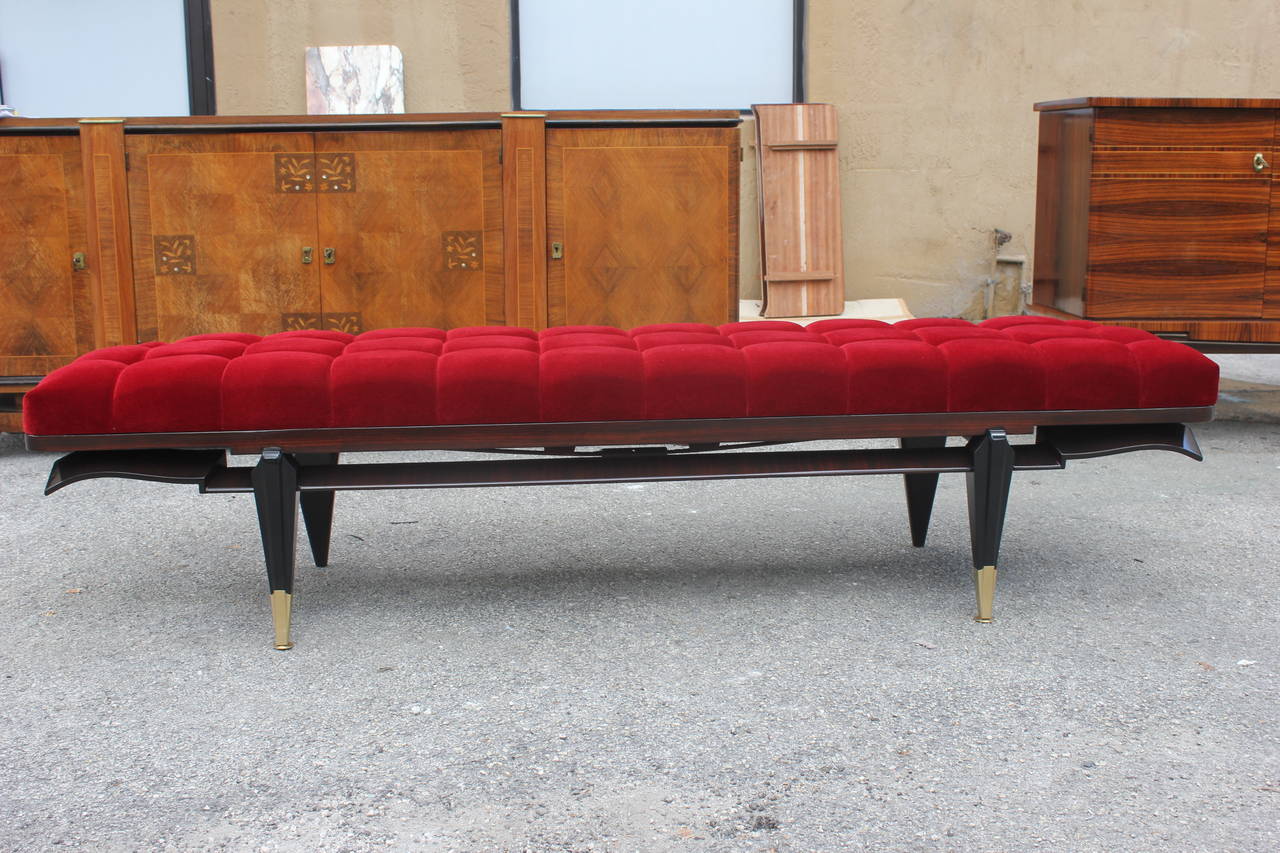 A French Art Deco exotic Macassar ebony black lacquered red velvet sitting bench, circa 1940s. Newly upholstered.