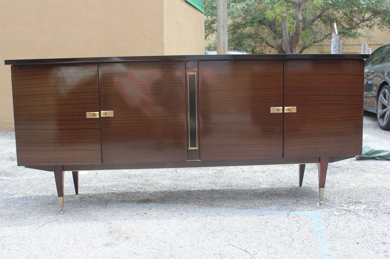 A French Art Deco or art moderne mahogany buffet, circa 1940s. Finished interior, all keys present.