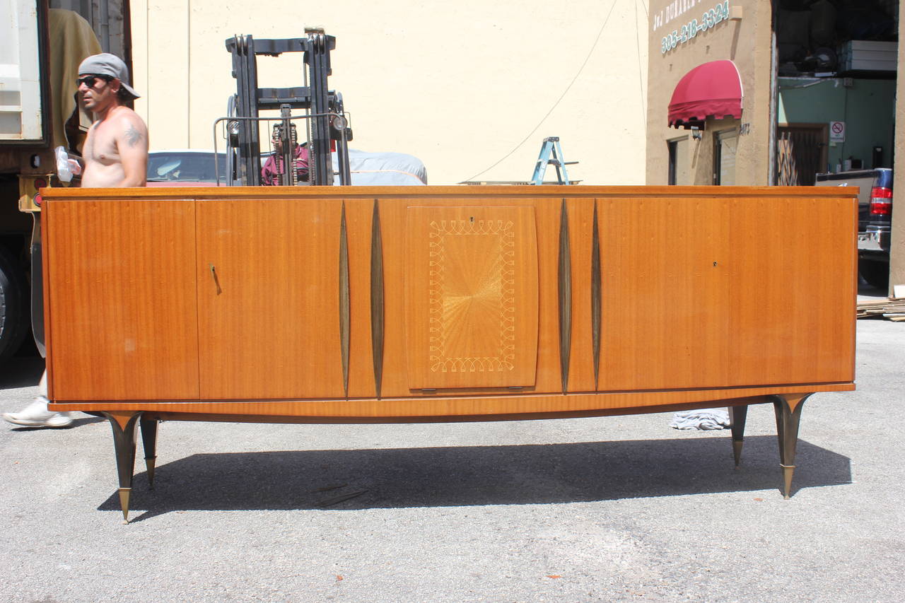 A grand scale French Art Deco Sideboard / Buffet  flame mahogan, high gloss finish circa 1940s. Black lacquer accents. Center line of drawers.