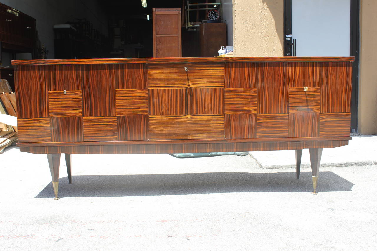 A French Art Deco/ Art Moderne Exotic Macassar Ebony Buffet, circa 1940's. Square patterned, interior finished in Lemonwood. Center drop down bar area.