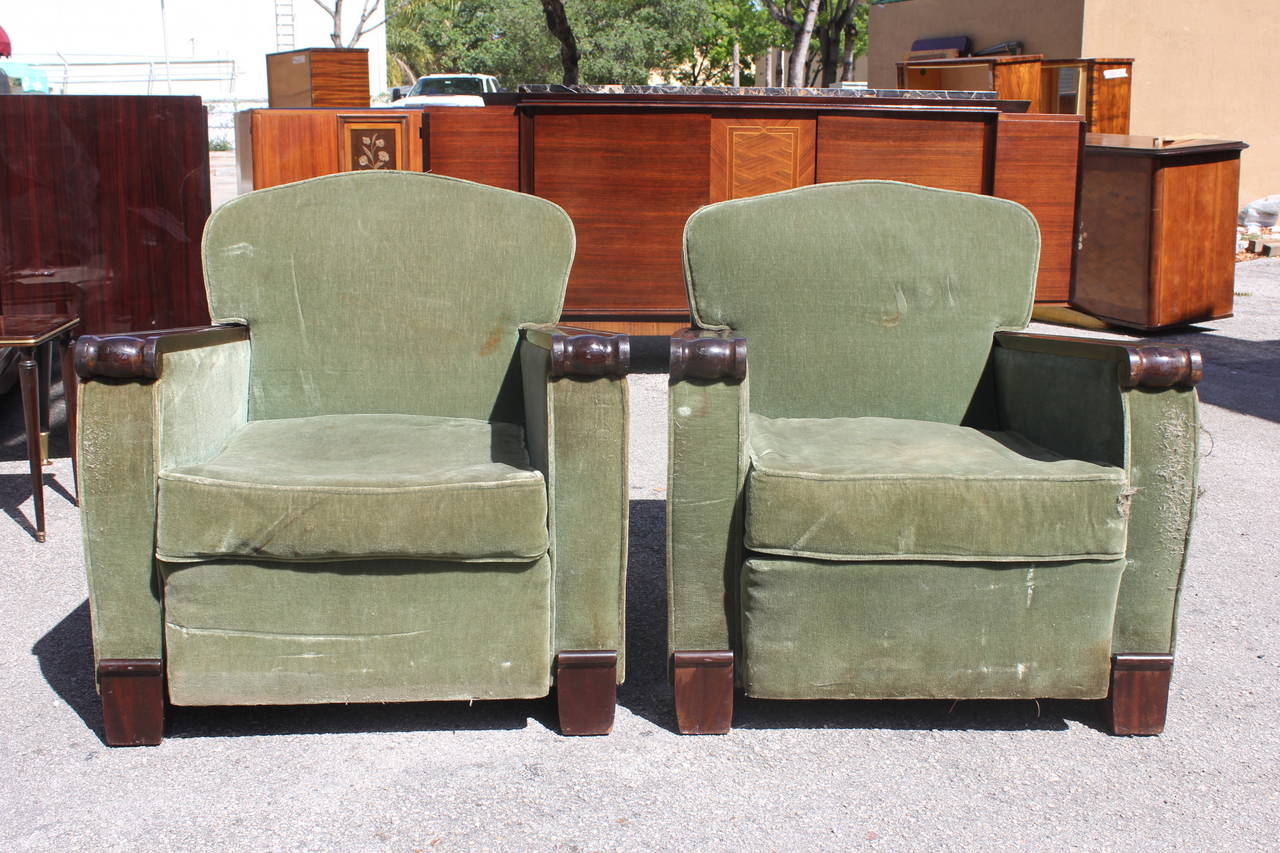A pair of French Art Deco club chairs by Gaston Poisson, circa 1940s. Solid mahogany. Reupholster recommended.