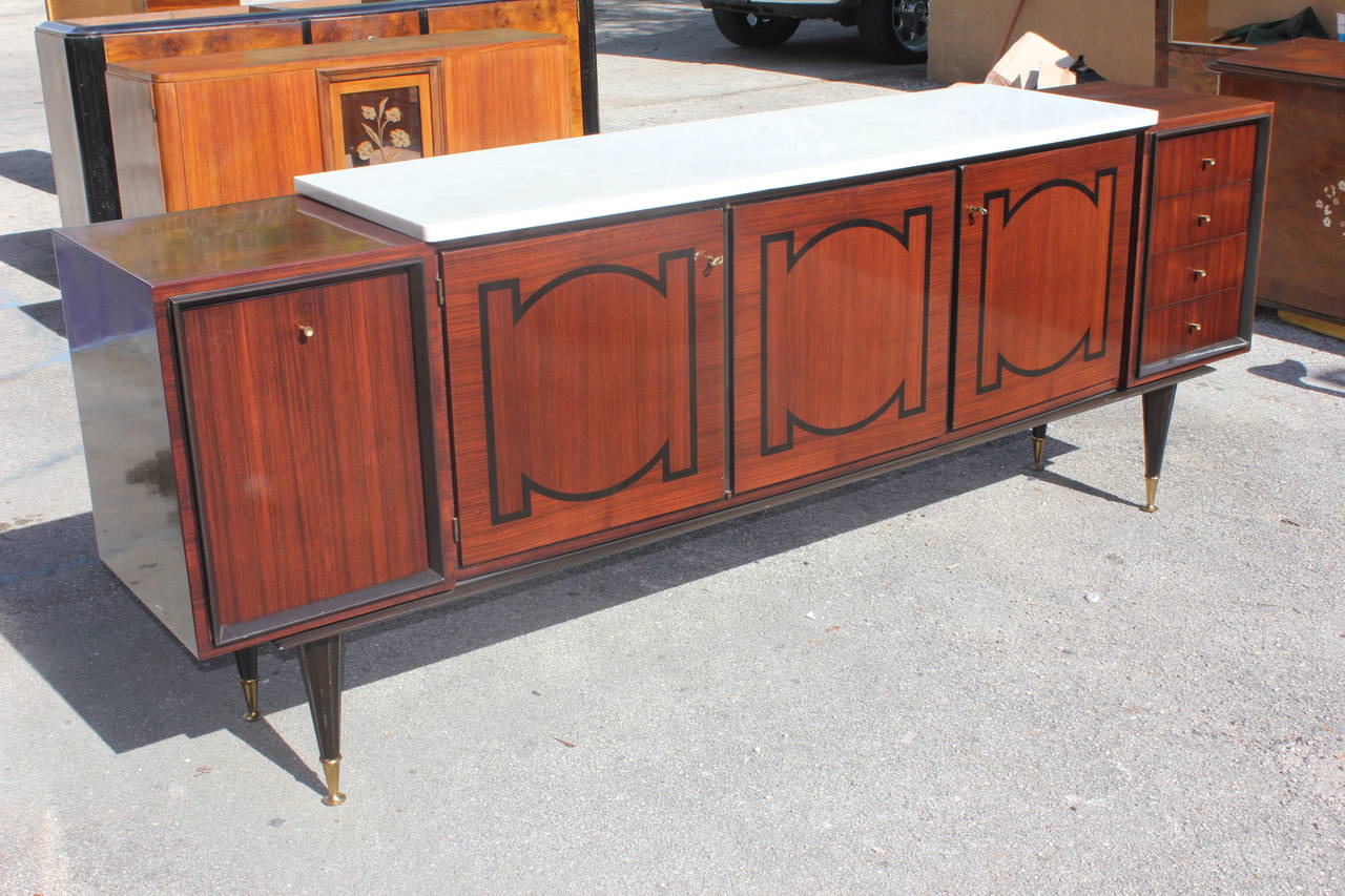 A French Art Deco sideboard or buffet palisander with ebony inlay and white marble top, circa 1940s. Finished interior. High gloss finish.