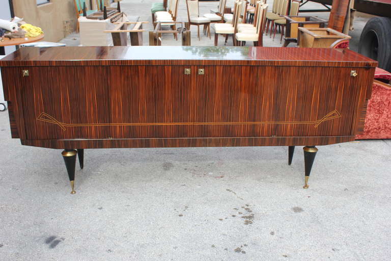 A French Art Deco or Art Moderne exotic Macassar ebony buffet or sideboard. Interior finished in lemonwood. Ribbon inlays detail.