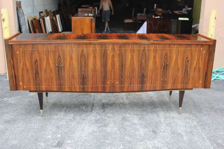 A French Art Deco or Art Moderne exotic Macassar ebony buffet or sideboard, circa 1940s. Interior finished in lemonwood, all keys present, excellent condition. Mother-of-pearl detail.