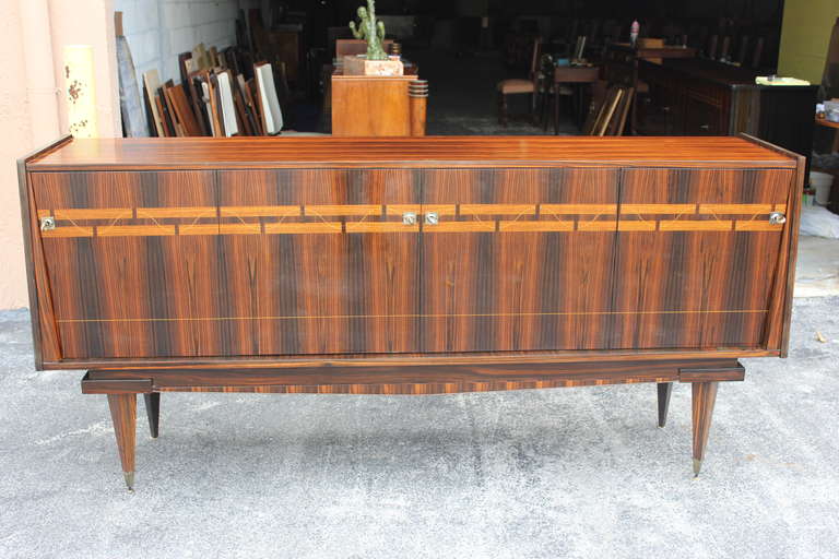 A spectacular French Art Deco Exotic Macassar Ebony Buffet or Sideboard, circa 1940s. Interior finished in Lemonwood, original keys present, excellent condition.