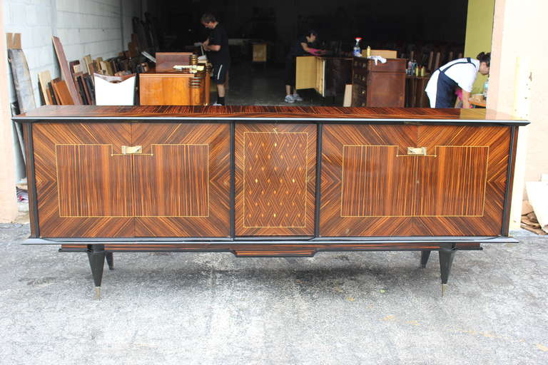 A Pair of Grand Scale French Art Deco Exotic Macassar Ebony Buffets. Stunning inlay, center bar area. All original keys present, interior finished. Again this sale is for a pair.