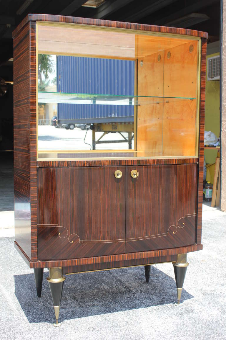 A French Art Deco/ Moderne Exotic Macassar Ebony Dry Bar/ Vitrine/ Display Case. Lower storage compartment, upper glass doors and glass interior shelf.