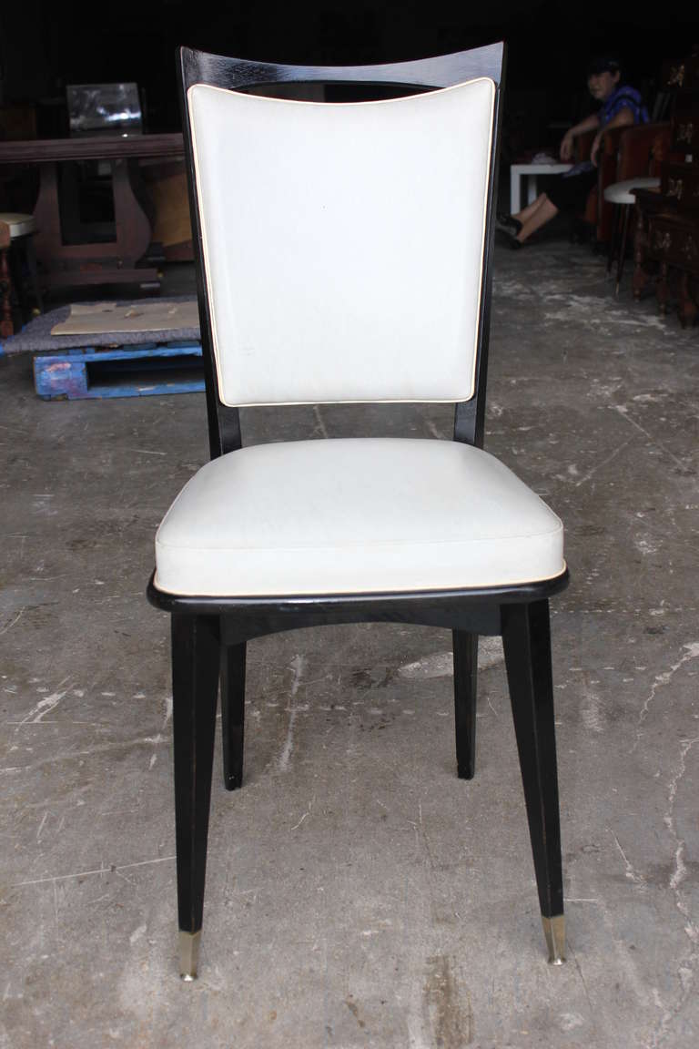 A set of 8 matching French Art Deco Black Ebony Dining Chairs, circa 1940's. Reupholstery recommended.