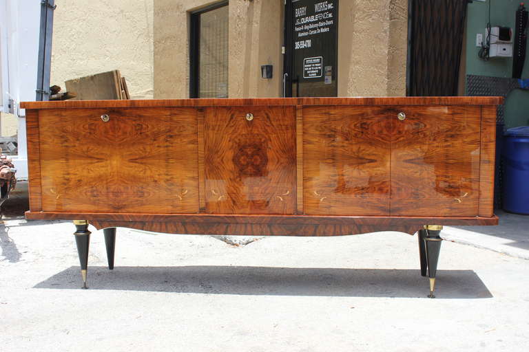 A stunning pair of French Art Deco Exotic Walnut Grand Buffets. Center bar area, finished interior. Excellent condition.