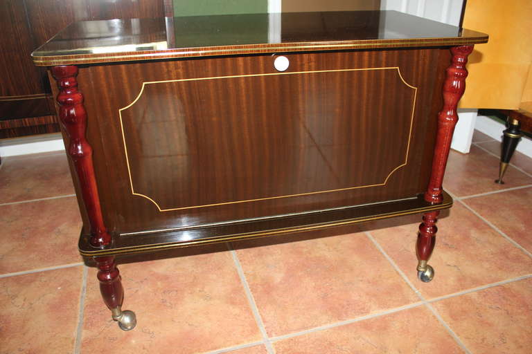 A French Art Deco Flame Mahogany Rolling Dry Bar. Finished interior.