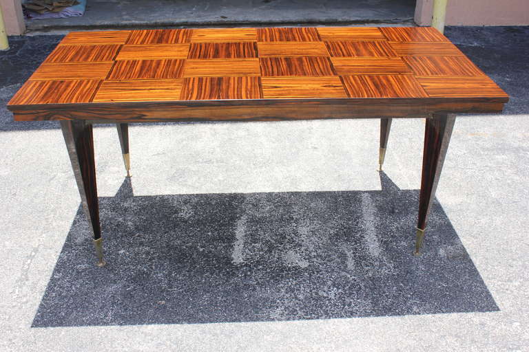 A French Art Deco Exotic Macassar Ebony Marquetry Inlay Dining Table, circa 1940's. Stunning table with exotic macassar legs.