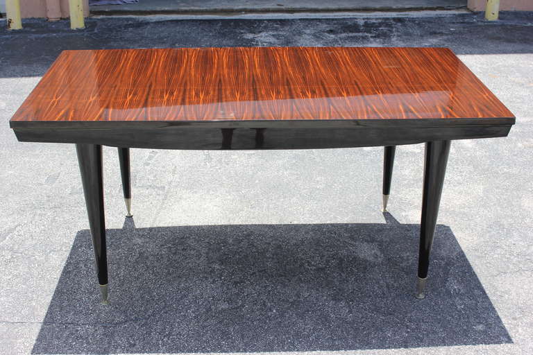 A French Art Deco Exotic Macassar Ebony Dining Table, circa 1940's. Excellent condition. Black Lacquer legs.