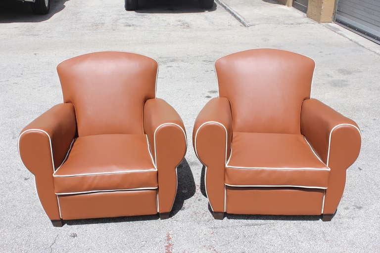 Pair of French Art Deco club chairs in vinyl upholstery. Restored condition. Soft cushion.