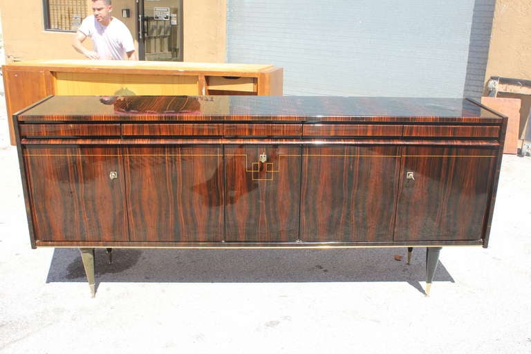 A French Art Deco exotic Macassar ebony buffet, center bar area, top line of drawers. Finished interior.