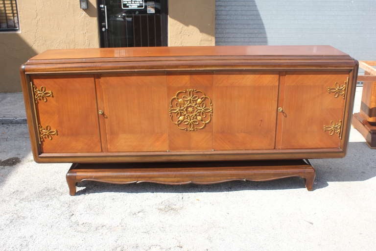 A Grand French Art Deco palisander buffet by Jean Desnos. Elaborate centre medallion and hardware. Finished interior.