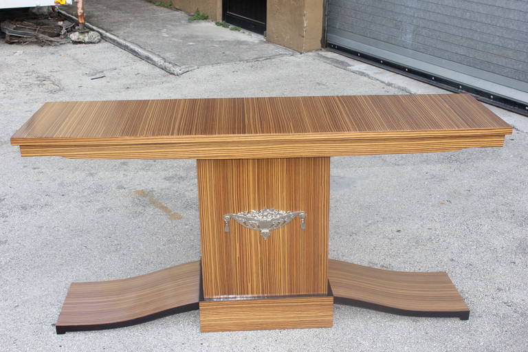 A French Art Deco Exotic Zebrawood Console Table, circa 1940's. Center nickel plated plaque.