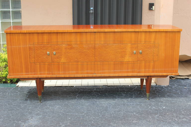 A French Art Deco flame mahogany buffet or credenza, circa 1940s. Interior finished, all keys present, very good condition.