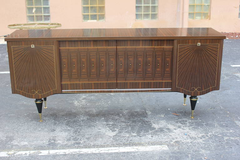 A French Art Deco Exotic Macassar Ebony Sunray Credenza/ Sideboard, circa 1940's. Interior finished, all keys present, very good condition.