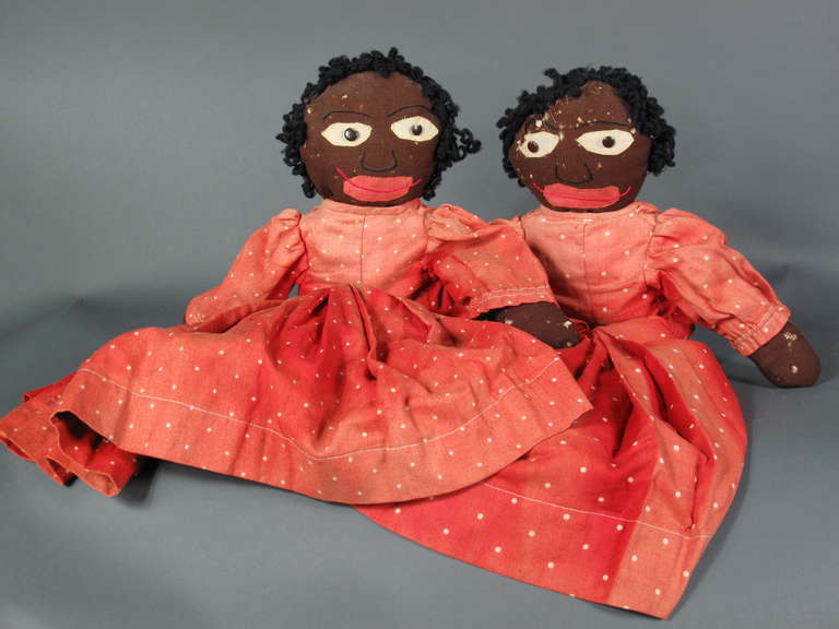 circa 1920.
Body constructed of black wool crepe. Stiffed with cotton batting.
Facial features are embroidered, eyes embellished with buttons and yarn for hair. Each doll wears authentic children's shoes.
Featured in Country Home Magazine.