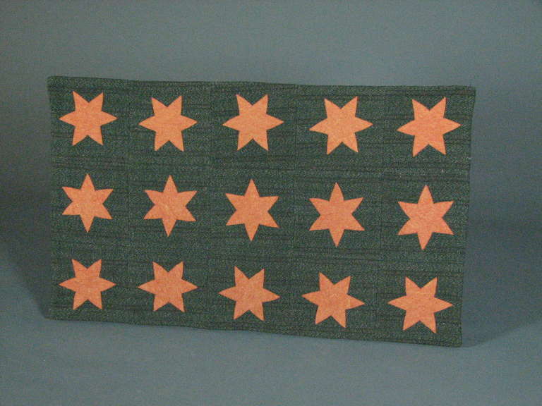 20th century
Felted wool tweed
Fifteen orange felt stars appliqued on charcoal tweed
Velcro mounted.