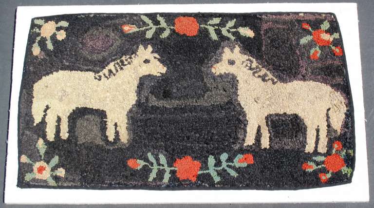 Found in Pennsylvania
1920 - 1930
Great folky hand hooked pictorial rug with
horses and red flowers.