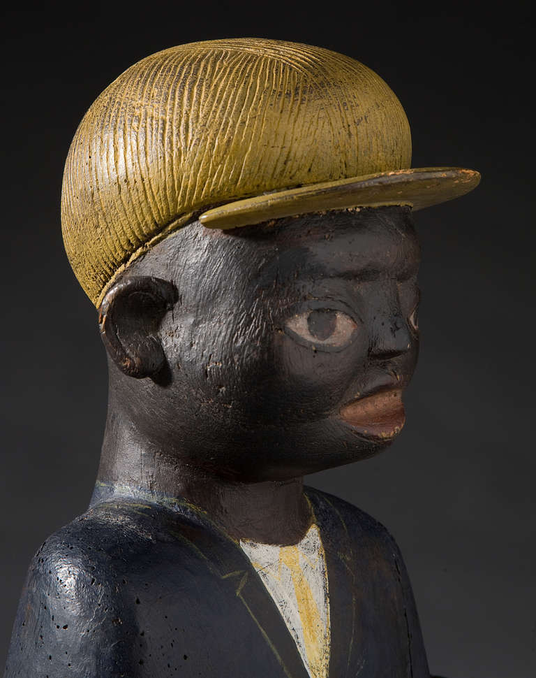 Circa 1920
Wood and original polychrome.
African American bust wearing yellow cap.
Sits on a wooden platform.