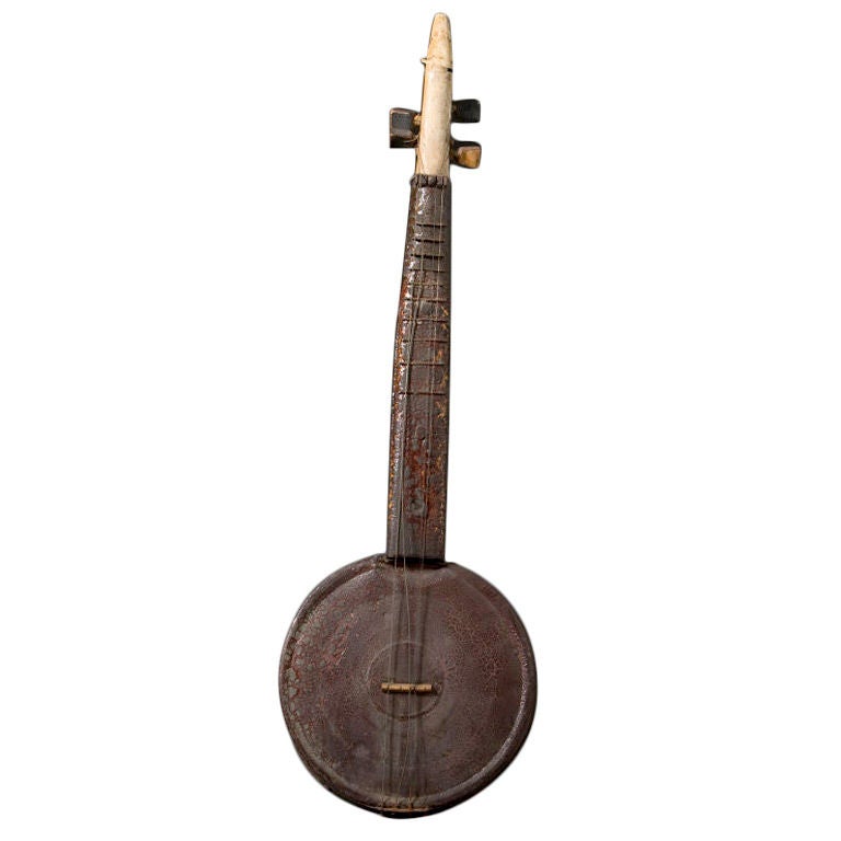 Hand-made banjo with tin body and wooden neck.<br />
Unusual carved goose head at end of neck.